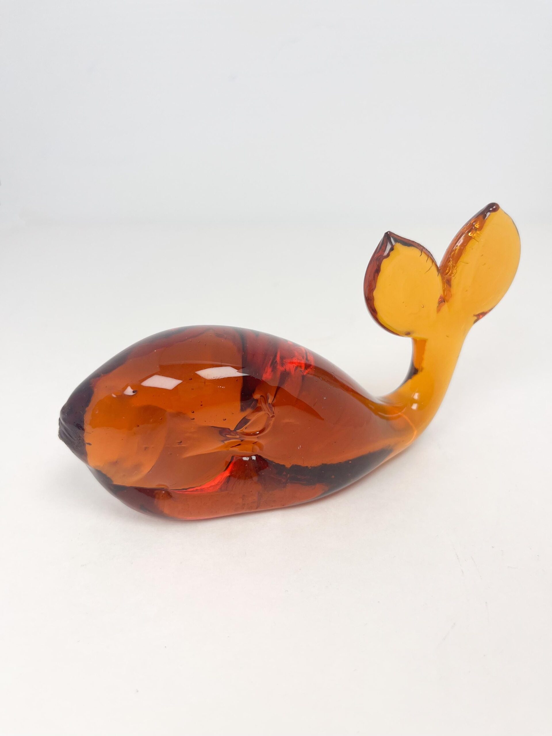 Vintage hand blown amber coloured glass whale paperweight