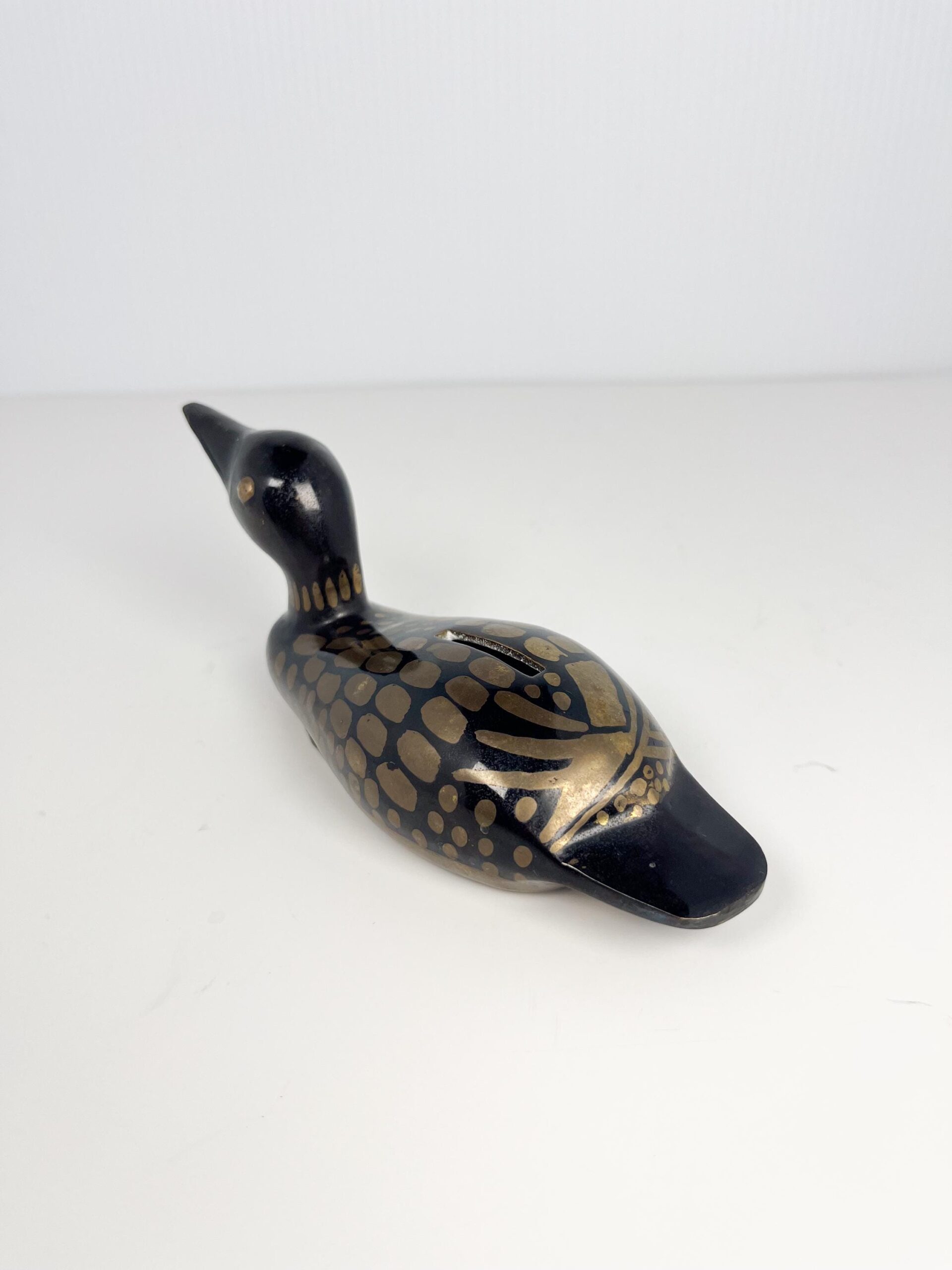 Small brass painted loon coin bank