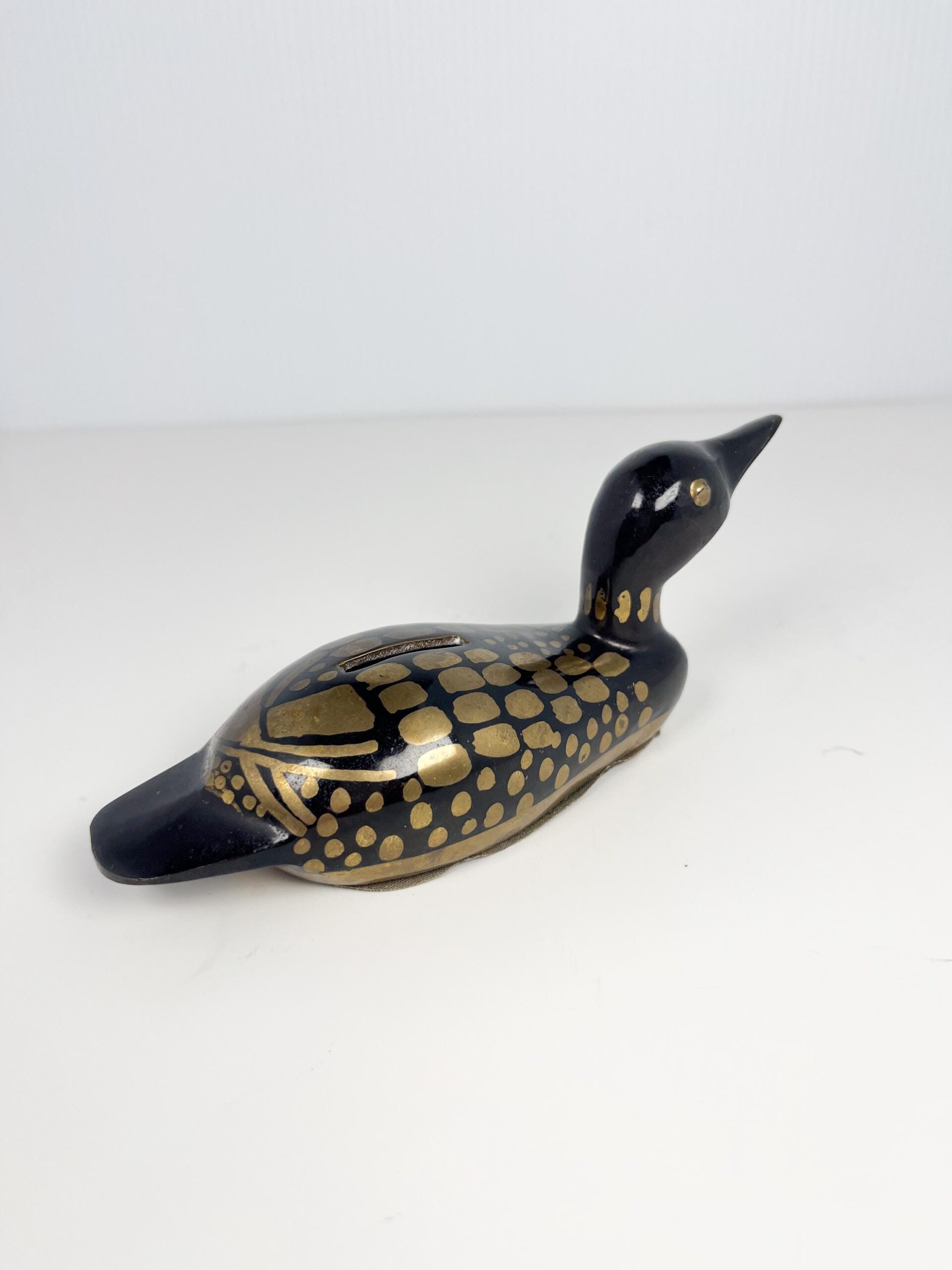 Small brass painted loon coin bank