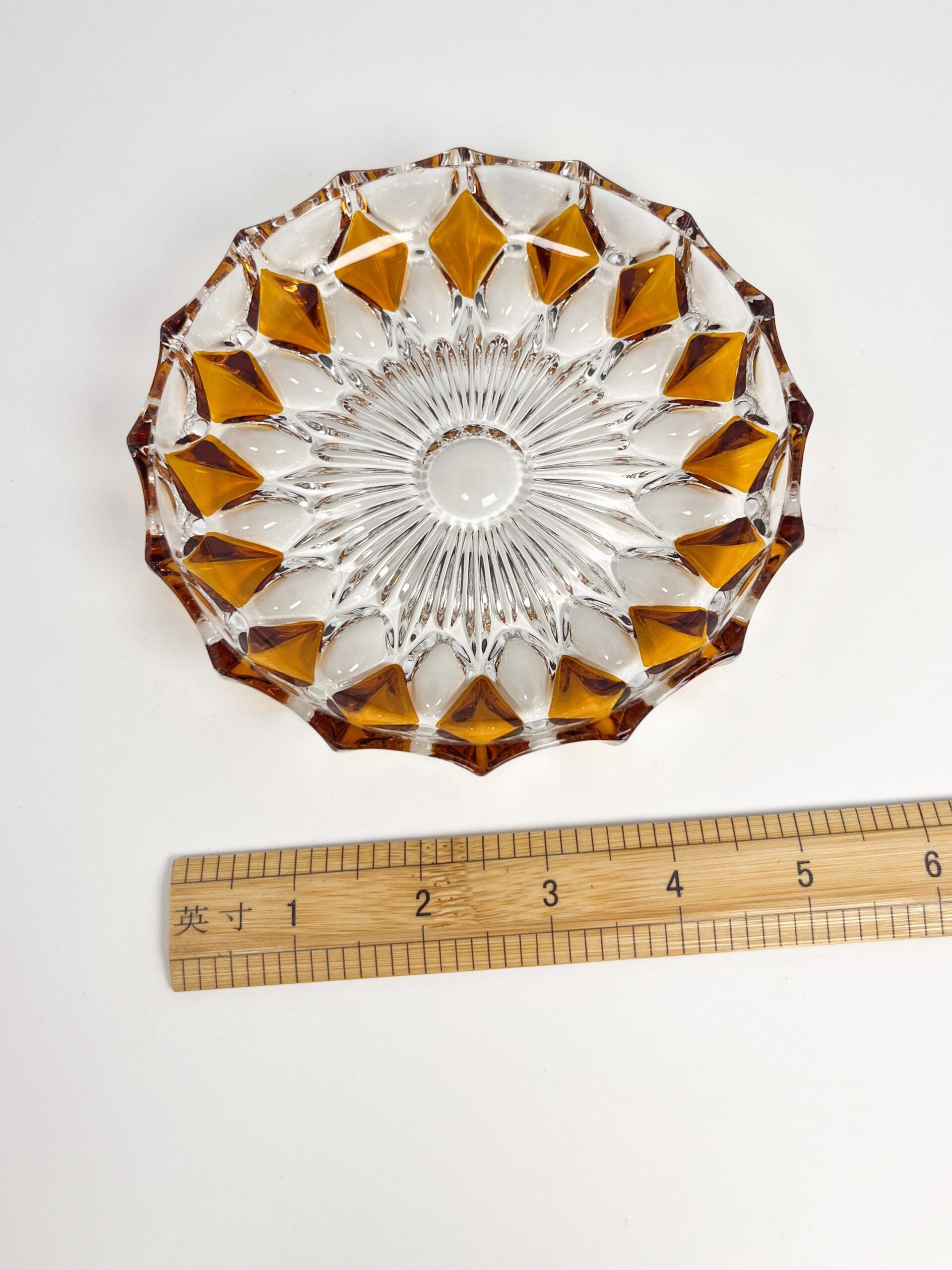 Vintage faceted crystal ashtray with amber coloured diamond motif