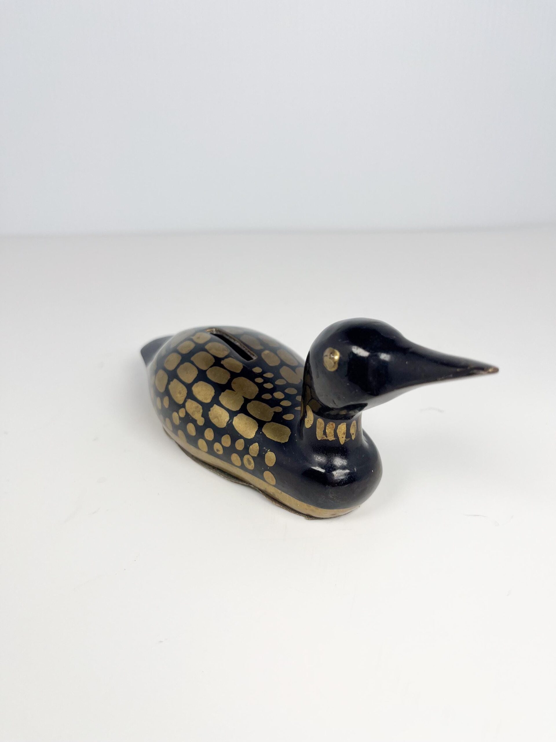 Small brass painted loon coin bank