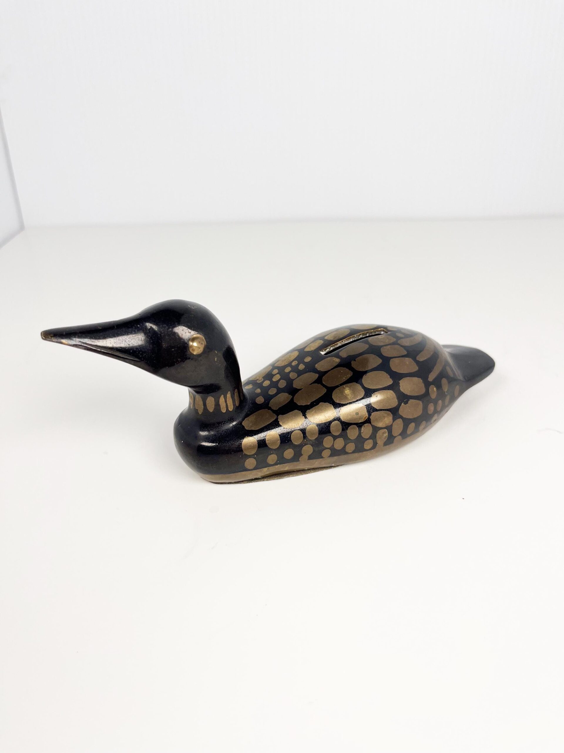 Small brass painted loon coin bank