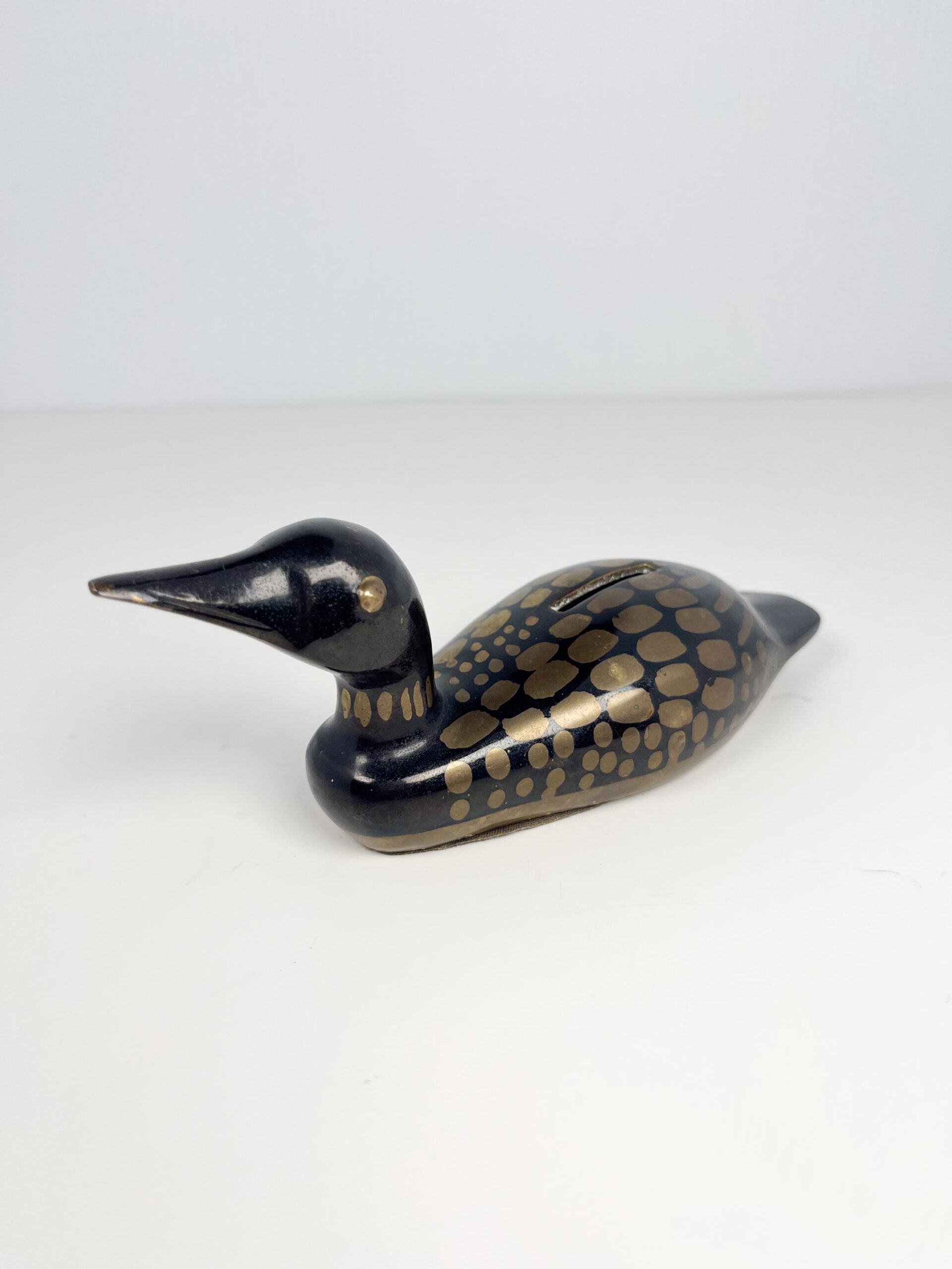 Small brass painted loon coin bank