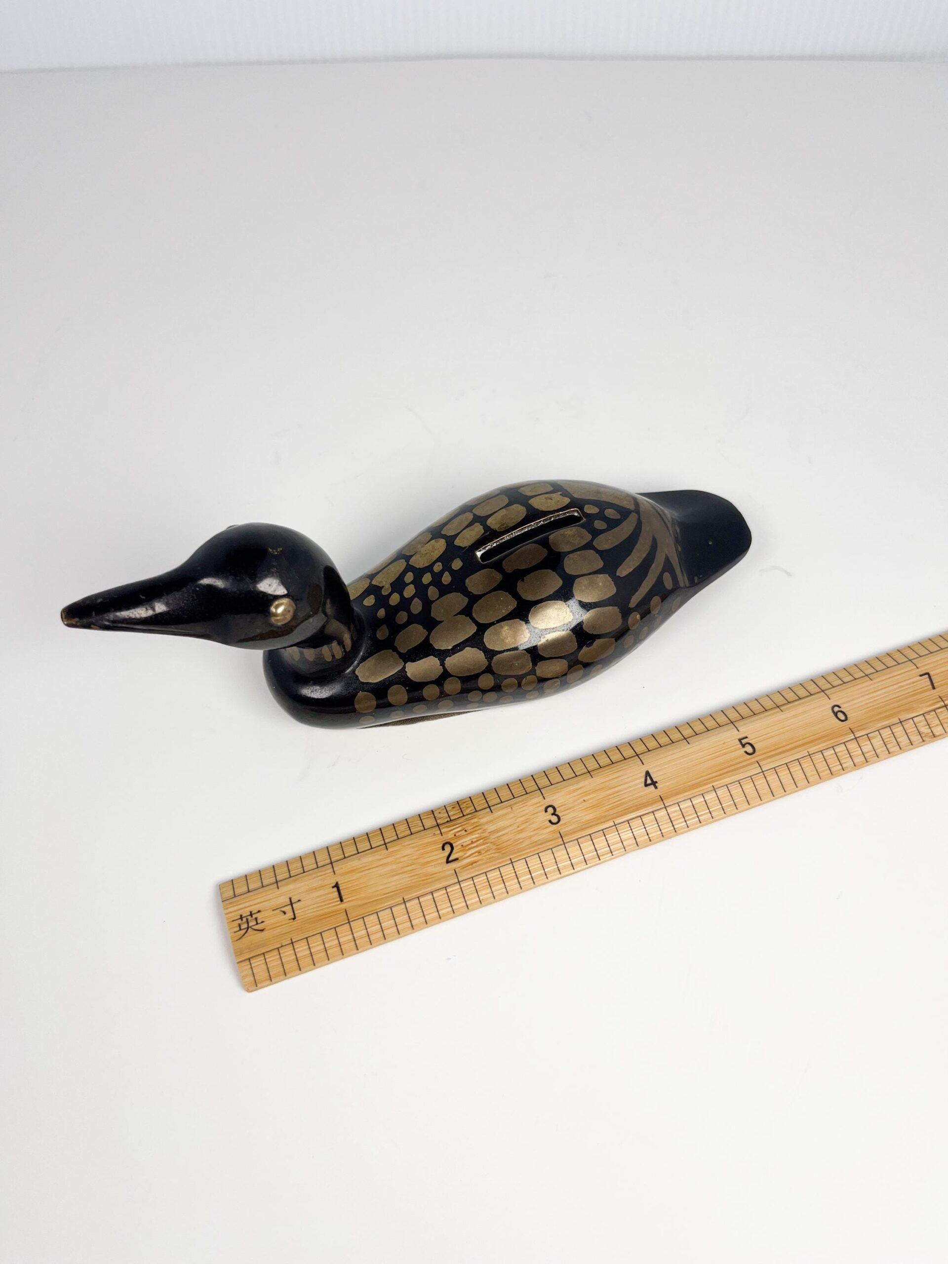 Small brass painted loon coin bank